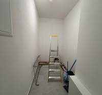 Storage space with a ladder, broom, and drying rack in a 3-room apartment.