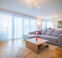 Living room in a family house with a spacious sofa and a wooden decor floor.