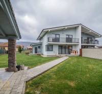 A family house on Krátka Street in Spišské Bystré with a well-maintained lawn and a shelter.