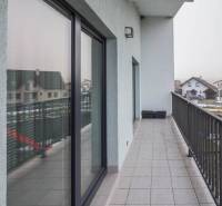 The balcony of a family house on Krátka Street in Spišské Bystré with tiles and glass railing.