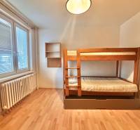 Children's room in a three-room apartment with a bunk bed and a floor with a wooden decor.