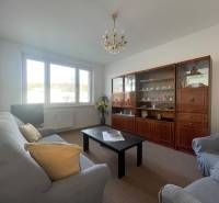 Living room in a 3-room apartment with a sofa, armchairs, and a wall unit.