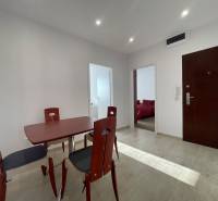 Dining table and chairs in the hallway of a 3-room apartment with tiles.