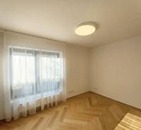 A room with a ceiling light and a floor with a wood decor in a 4-room apartment.