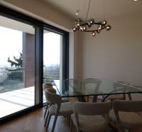 Dining table with a glass top, floor with wood decor, light fixture in a 4-room apartment.