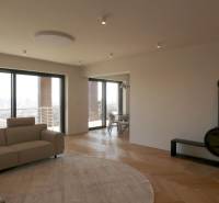 Living room with a sofa, fireplace, and wooden decor flooring in a 4-room apartment.