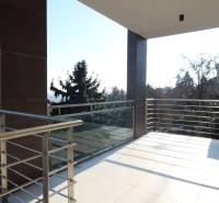 A balcony with a railing and a view of the city from a 4-room apartment in Bratislava.