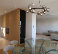 Living room with a dining table, sofa, and light fixture in a 4-room apartment, floor with wood decor.