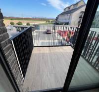 The balcony of a 2-room apartment at Námestie pri sýpke in Bratislava - Jarovce with a view of the surroundings.