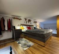 Bedroom with a bed, wardrobe, and wooden decor flooring, furnished from Warehouses and Halls.