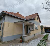 A family house in Trnovec nad Váhom with a landscaped garden and a garage on a quiet street.