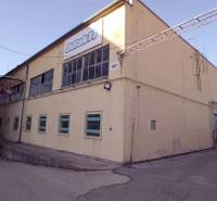 Building on Coburg Street in Trnava, warehouses and halls, yellow exterior, industrial architecture.