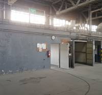 Industrial interior with gray walls, doors, and ventilation system in the warehouse and hall.