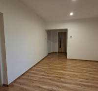 Interior of a family house with white walls and a wooden decor floor.