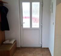 Interior of a family house with glass doors and a wooden decor floor.