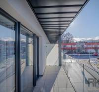 A balcony with a glass railing at a 2-room apartment on Francisciho Street in Poprad.