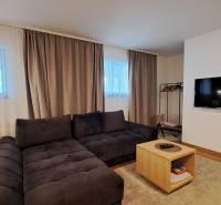 Living room in a two-room apartment with a comfortable sofa and a wooden decor floor.