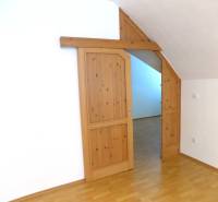 Interior with wood-patterned flooring and sliding doors in a building.