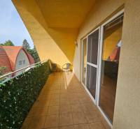 A balcony with tiles in a building on Námestie detí in Galanta with a view of the rooftops.