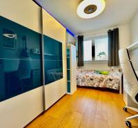 Children's room in a 4-room apartment with a bed, desk, and wardrobe.