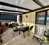 Terrace of a 4-room apartment with seating, a roof, and a flower nook.
