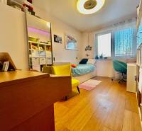 Children's room in a 4-room apartment with a wooden decor floor and furniture.