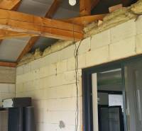 A family house in Semerovo with an exposed wooden beam ceiling and makeshift electrical wiring.