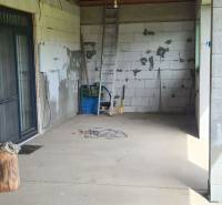 The interior of a family house with gaudy walls, a ladder, and construction materials.