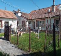 A family house in Nové Zámky with a small garden and a satellite dish on the roof.