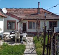 A family house in Nové Zámky with a terrace, plastic chairs, and a satellite dish.