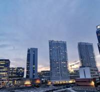 The panorama of high-rise buildings on Bottova Street in Bratislava at dusk.