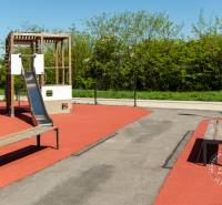 Children's playground with a modern slide and benches on Michala Bučiča Street in Bratislava.
