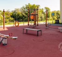 A playground with climbing frames and swings, next to Michal Bučič Street, suitable for families.