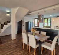 Dining room and staircase in a family house with a wooden decor floor, open space.