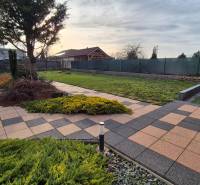 The garden at the family house on Veterná Street in Krakovany with paving and a terrace.