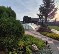 The garden at the family house on Veterná Street in Krakovany with a pool cover.