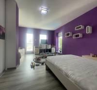 Purple and white children's room with wood-patterned flooring in a family house.