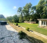 Terrace of a family house in Melčice-Lieskové with a garden, swimming pool, and gazebo.