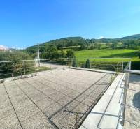 The terrace of a family house in Melčice-Lieskové with a view of the surrounding green landscape.