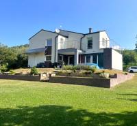 Family house in Melčice-Lieskové with a landscaped garden and parking on a grassy plot.