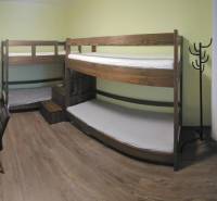 A room in a 3-room apartment with a bunk bed, a desk, and a floor with a wooden decor.