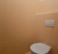 A restroom with beige tiles in commercial premises.