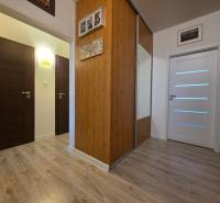 Interior of a 3-room apartment with a wooden decor floor and a built-in wardrobe.