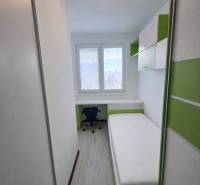 A cozy room with a bed, a desk, and storage space in a 3-room apartment.