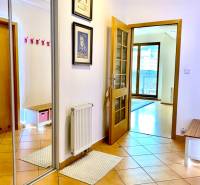 Hallway in a 2-room apartment with terracotta tiles and a mirrored wardrobe.