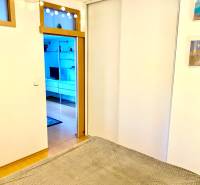 Interior of a 2-room apartment with sliding doors and a floor with a wood decor.