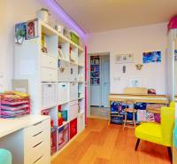 Children's room in a 4-room apartment with a wooden decor floor and plenty of storage space.