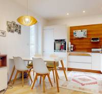 A kitchen in a 4-room apartment with a dining table, houseplants, and wooden decor.