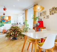 A bright living room with festive decorations, a dining table, and plants in a 4-room apartment.