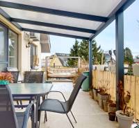 A terrace with a glass table and chairs in a 4-room apartment.